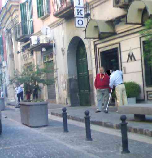 Via Roma, un commerciante spazza fuori al suo negozio